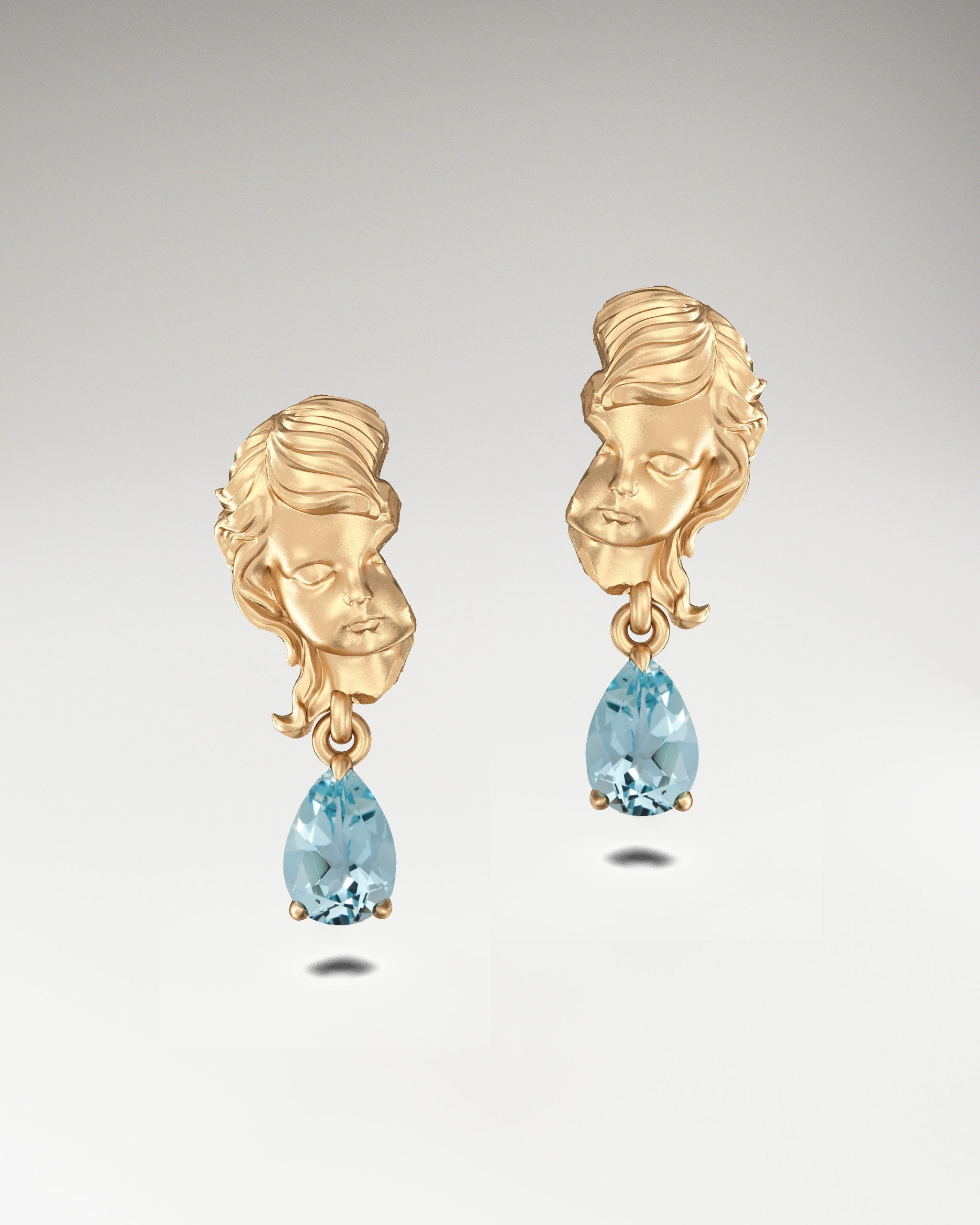 Gold dangle earrings with aquamarine gemstones